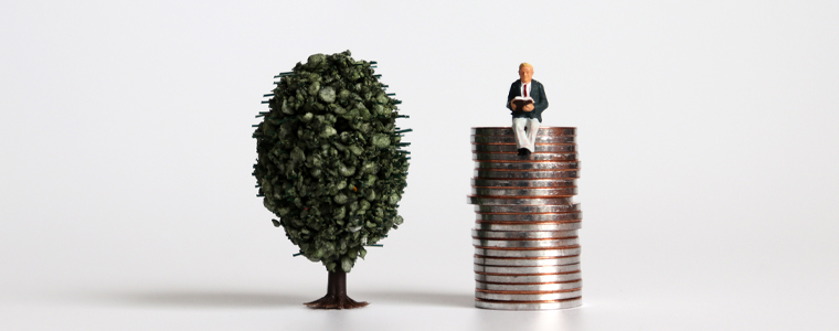 miniature man on stack of coins