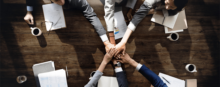 teamwork hands across table