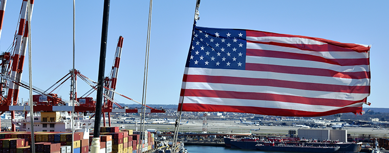 American Flag at a shipping yard with cranes in background