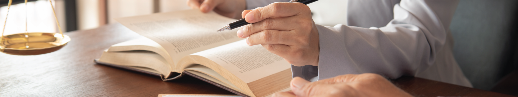 Lady justice on law book with lawyer team meeting in law office.
