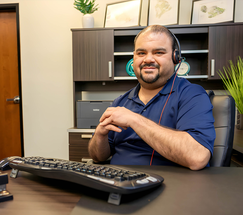 manager working at desk with keyboard